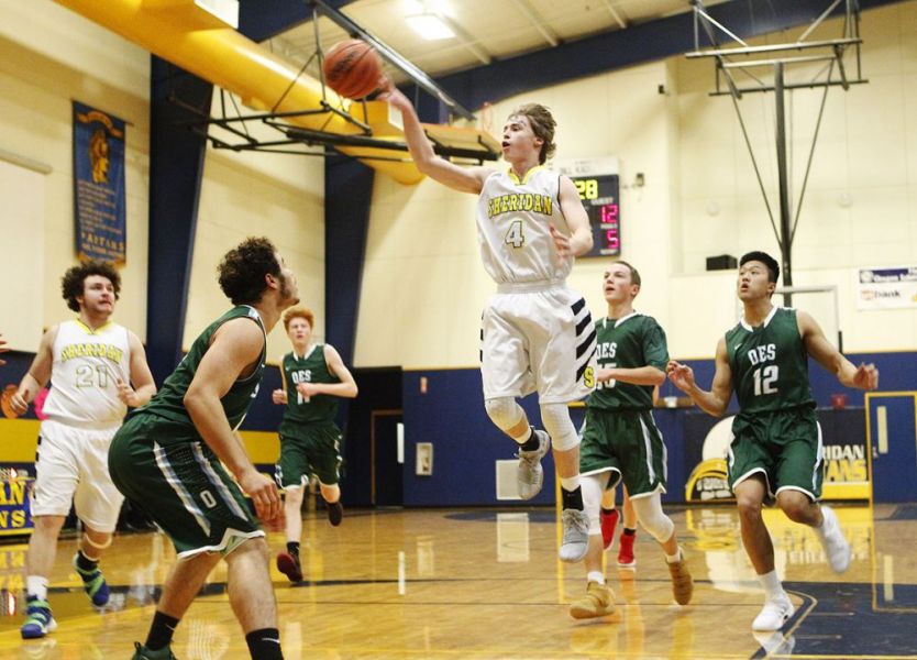 Rockne Roll/News-Register##
Sheridan s Joey Daniel attempts to dish a pass to a teammate during a fast break.