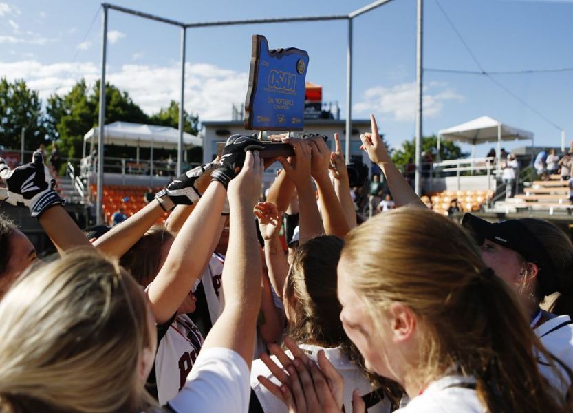 Rockne Roll/News-Register##
Dayton players hoist the OSAA Class 3A Softball State Championship Trophy after their extra-innings victory over Rainier in the title game Friday, June 1, at Oregon State University in Corvallis.