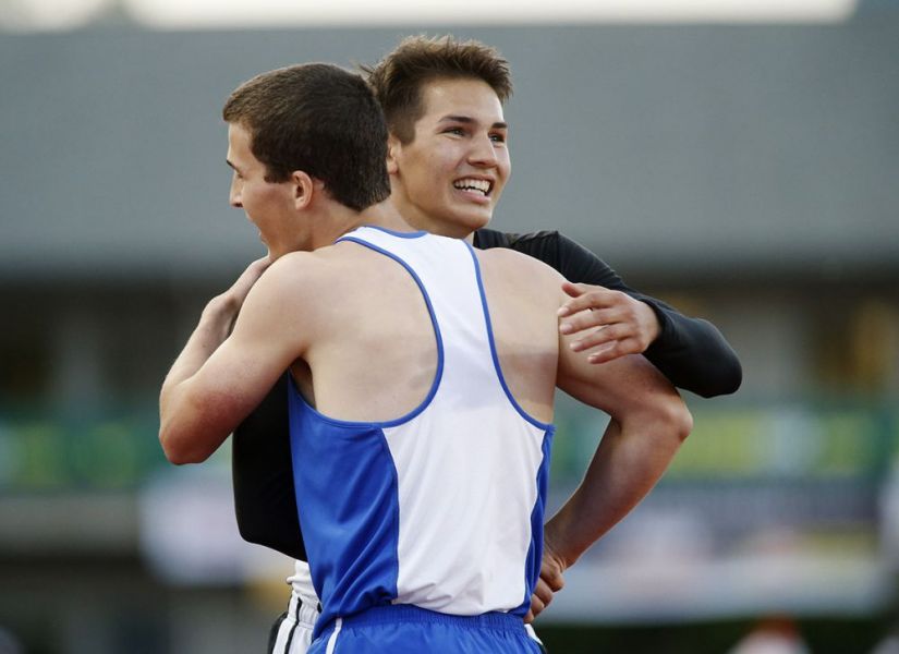 Rockne Roll/News-Register##
Dayton s Owen McLoud and Amity s Jonathan Mather embrace after the pair finished third and second in the boys  300m hurdles.