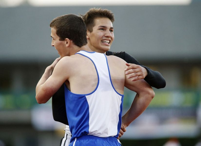 Rockne Roll/News-Register##
Dayton s Owen McLoud and Amity s Jonathan Mather embrace after the pair finished third and second in the boys  300m hurdles.