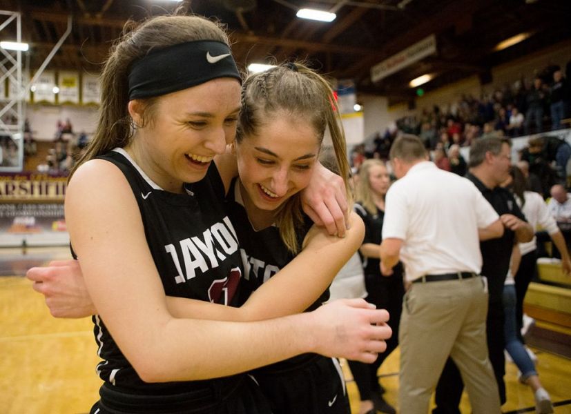 Rockne Roll/News-Register##
Dayton s Shawnie Spink (left) and Malina Ray celebrate their 3A girls basketball title.