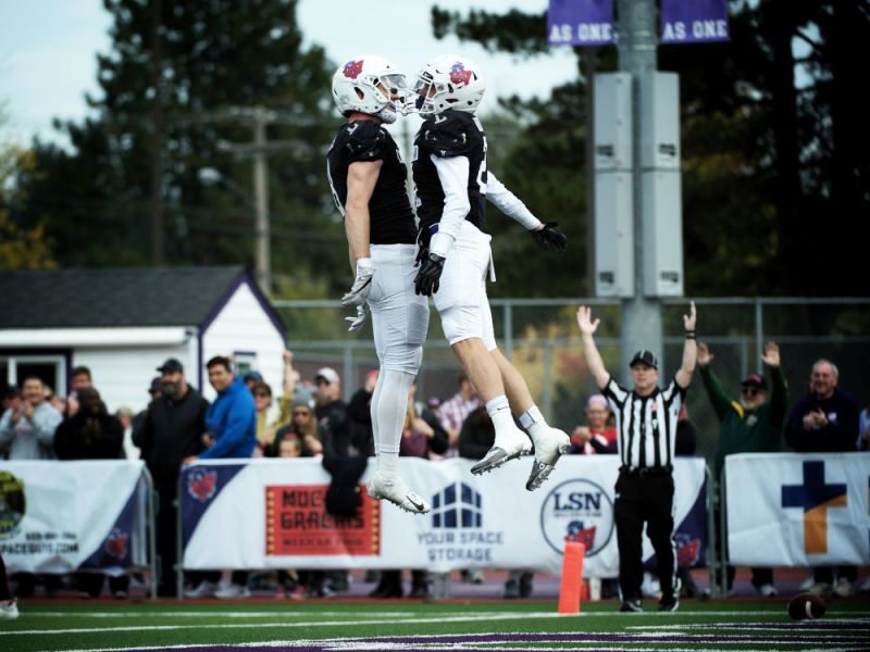 Marcus Larson/News-Register##
Linfield receivers Keaton Wood (left) and Tyler Torgerson celebrate a touchdown during Saturday s contest against UPS.