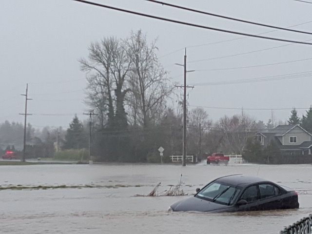 Photo submitted by Renee Lorenze##A car trapped in flood waters on SW Hill Road near SW Alexandria and Fellows Drive in McMinnville.