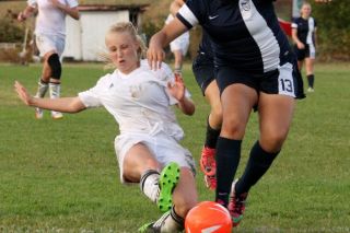 Rockne Roll/News-Register
Y-C s Megan Hawkins is taken down as she shoots for the goal in the Tigers  conference opener against Stayton.