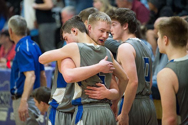 Marcus Larson/News-Register##
Amity teammates Tyler Parr and Michael Duncan console each other after their loss to De La Salle North Catholic.