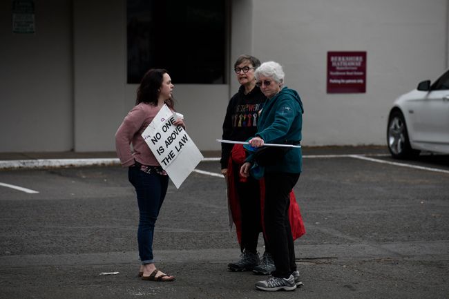 Rusty Rae/News-Register##
Three of the demonstrators reconnoiter as the protest at Third and Baker wound down. The moveon.org protesters are asking that the full Mueller investigation report be released.