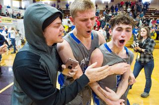 Marcus Larson/News-Register##
Michael Duncan, right, celebrates with Josh Wart and Trevor Smith after sinking the game-winning three-pointer against Dayton in the semifinal contest.