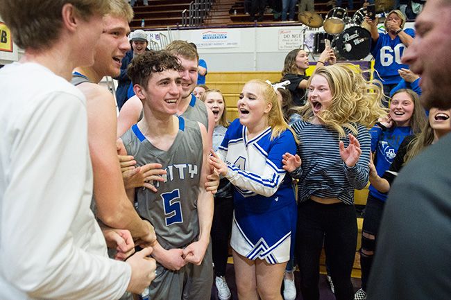 Marcus Larson/News-Register##
Michael Duncan celebrates with team members and classmates after sinking the game-winning three-pointer against Dayton in the semifinal contest.
