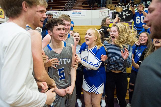 Marcus Larson/News-Register##
Michael Duncan celebrates with team members and classmates after sinking the game-winning three-pointer against Dayton in the semifinal contest.