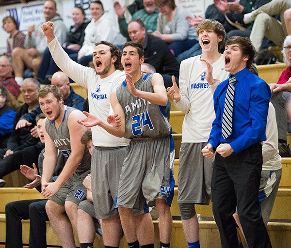 Marcus Larson/News-Register##
The Amity bench celebrates a clutch Warrior three-pointer late in the game against the Dayton Pirates.
