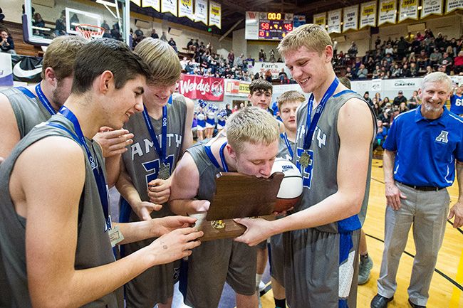 Marcus Larson/News-Register##
After receiving the second place trophy, Amity s Tyler Parr kisses the award in celebration.