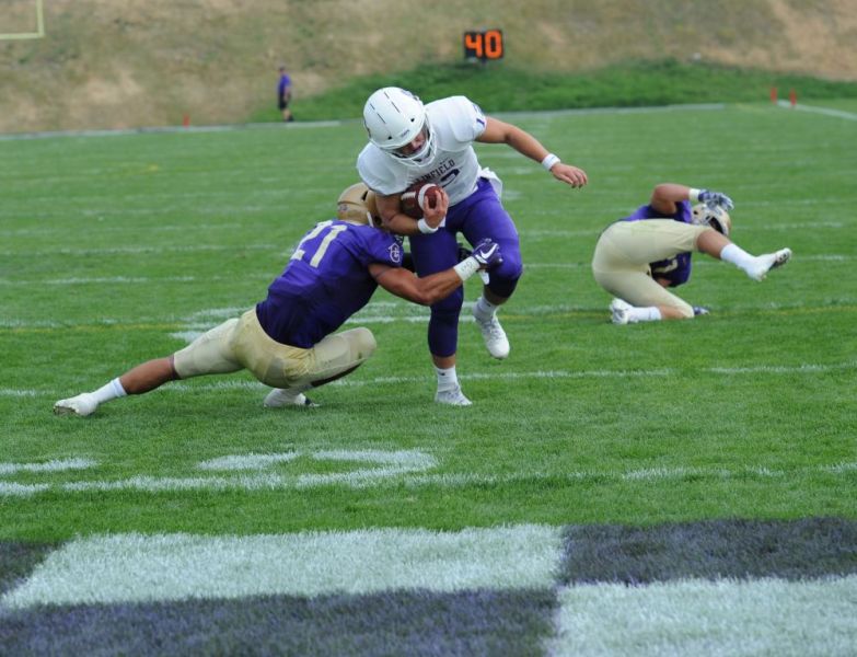 Rusty Rae/News-Register##
Linfield quarterback Wyatt Smith, a Mac Grizzly alum, leaves on defender on the ground and breaks a tackle of another on his way to scoring Linfiield s second TD, on a pass from Dawson Ruhl.